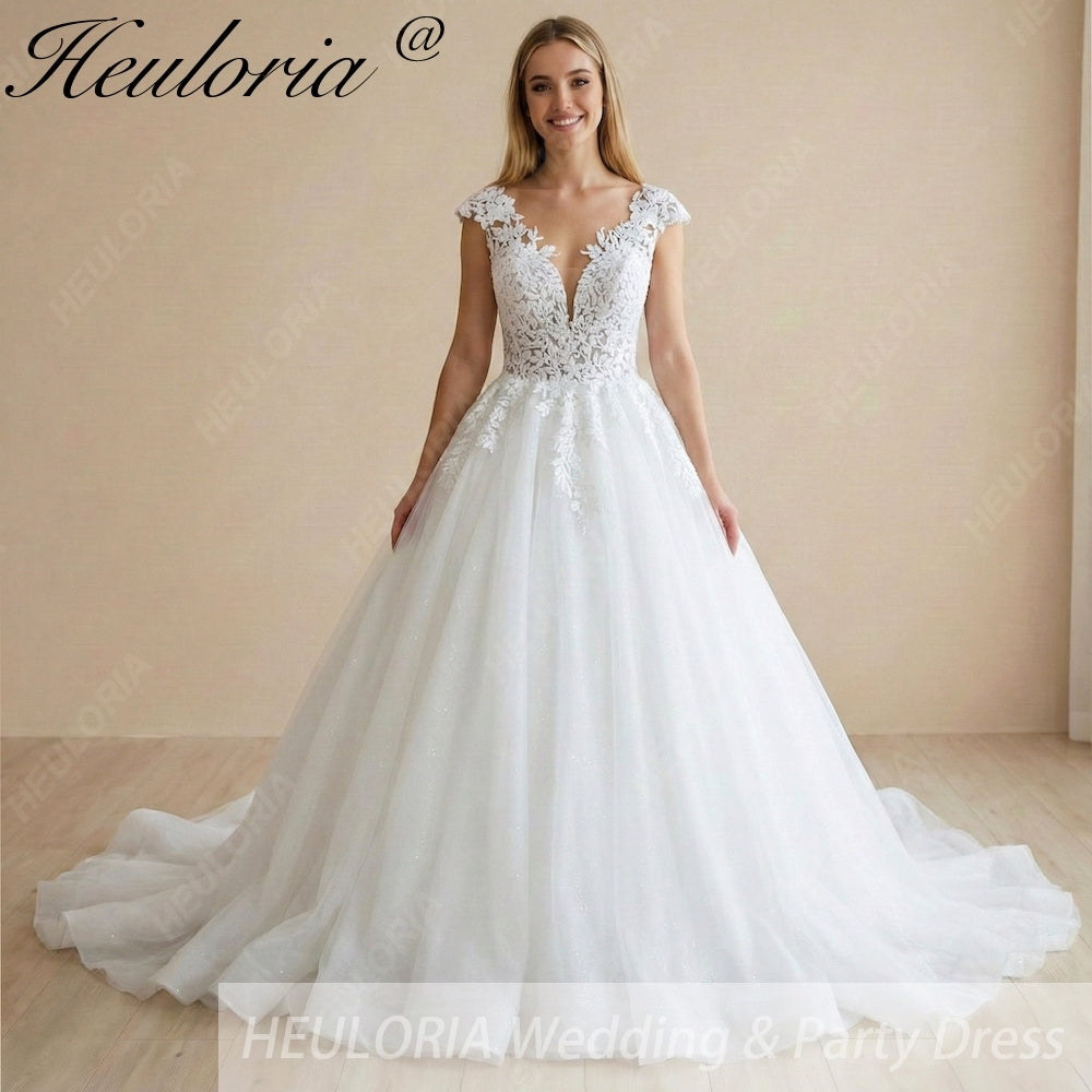 HEULORIA Enchanted Radiance: Plunging Illusion V-Neck Ball Gown Wedding Dress with Delicate Cap Sleeves BA-1075 Image principale du produit
