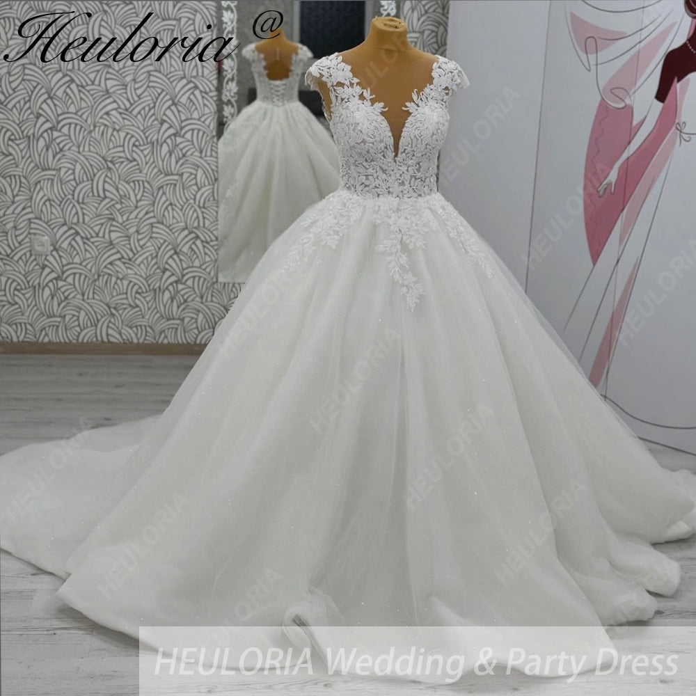 HEULORIA Enchanted Radiance: Plunging Illusion V-Neck Ball Gown Wedding Dress with Delicate Cap Sleeves BA-1075